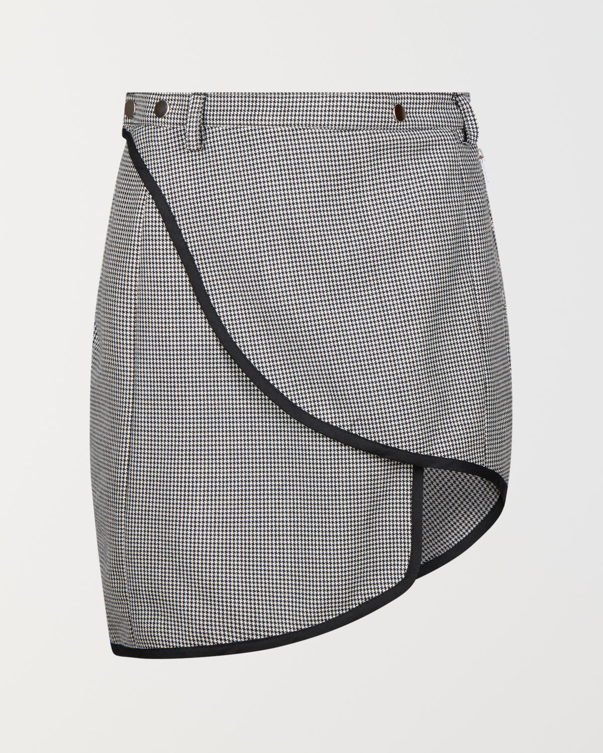 Stadion AM skirt in puppytooth, front view with the curved wrap hem bound in black