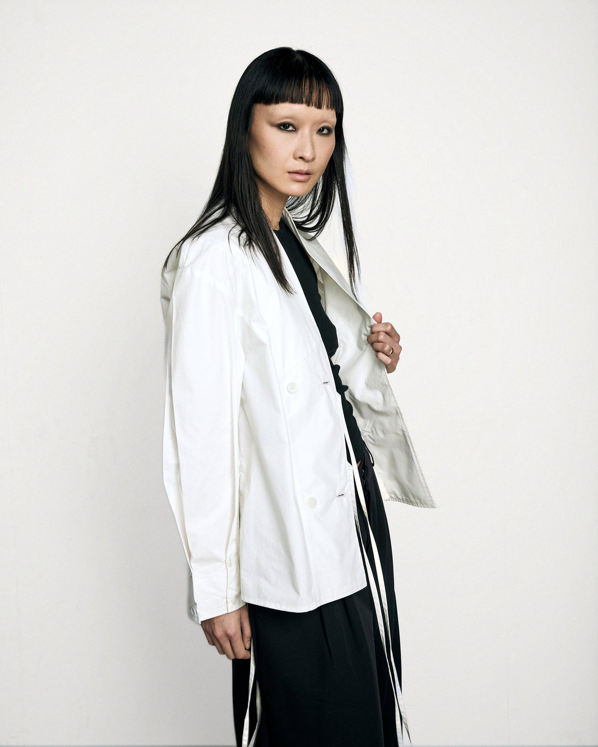 Woman wearing the Stadion Council shirt, three-quarter view with the ties loose