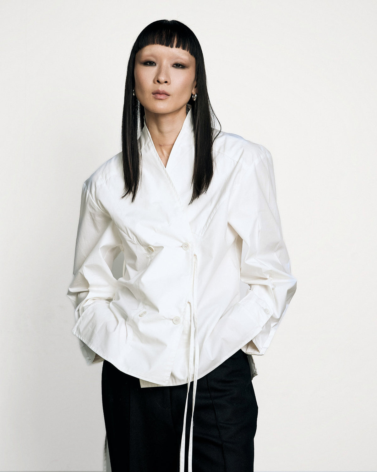 Woman wearing the Stadion Council shirt, front view with hands in pockets