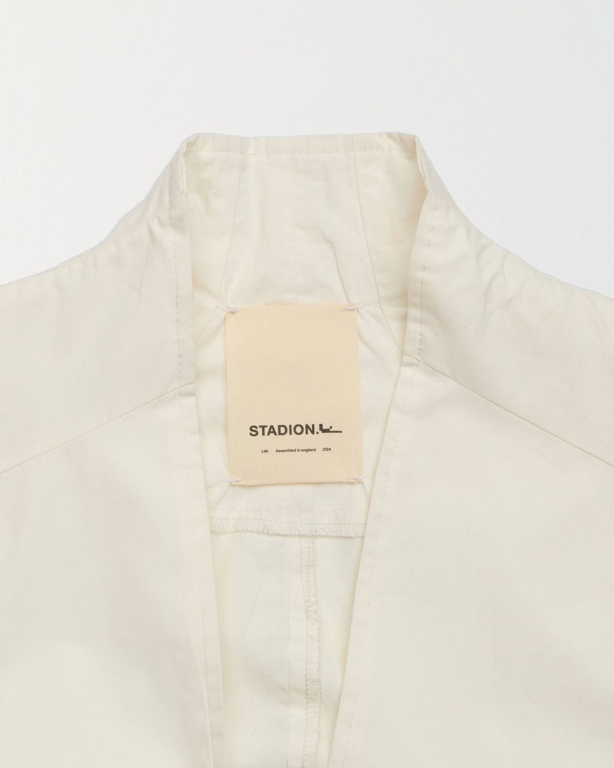 Detail of the stand collar and woven Stadion label inside the Council shirt