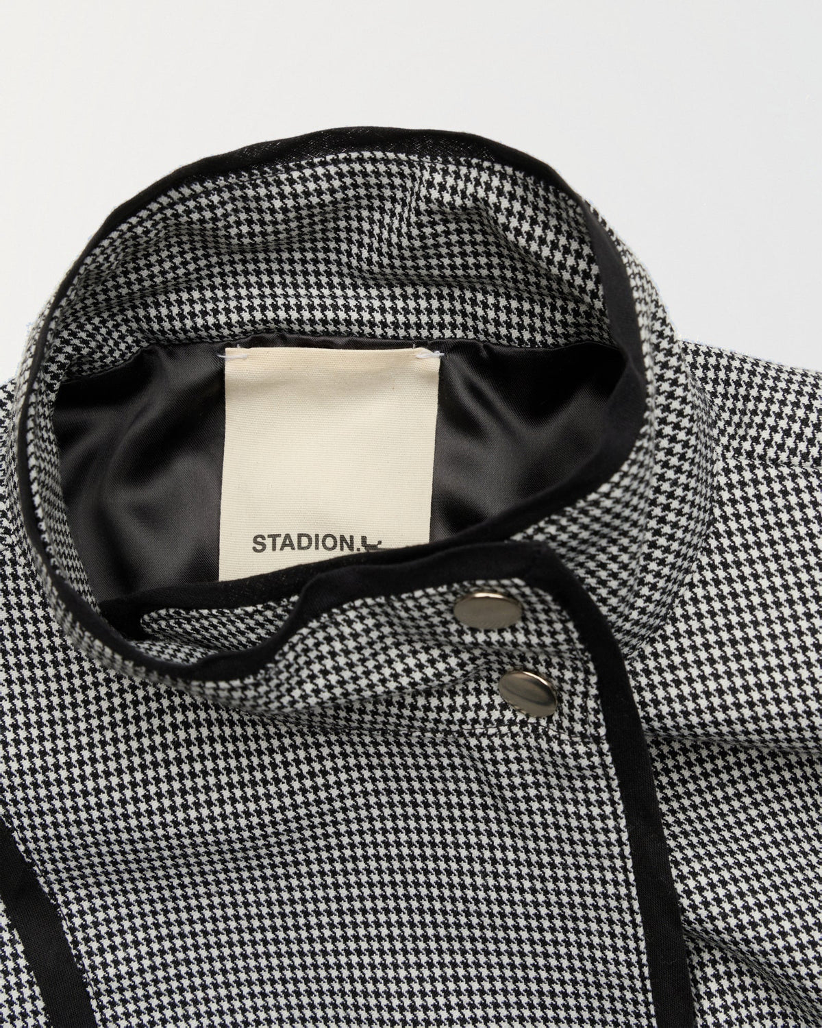 Detail of the collar, black satin lining and woven Stadion label in the Gibson coach jacket