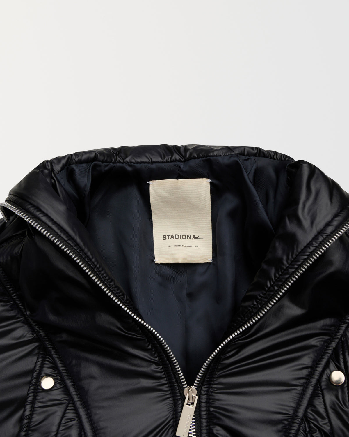 Detail of the collar, zip and woven Stadion label on the Reserve bomber