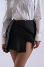 Front view of Stadion InMotion Skirt showing asymmetric wrap and pleated design.