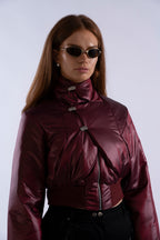 Angled view of Interface Bomber in Oxblood highlighting aluminium toggles and high collar.