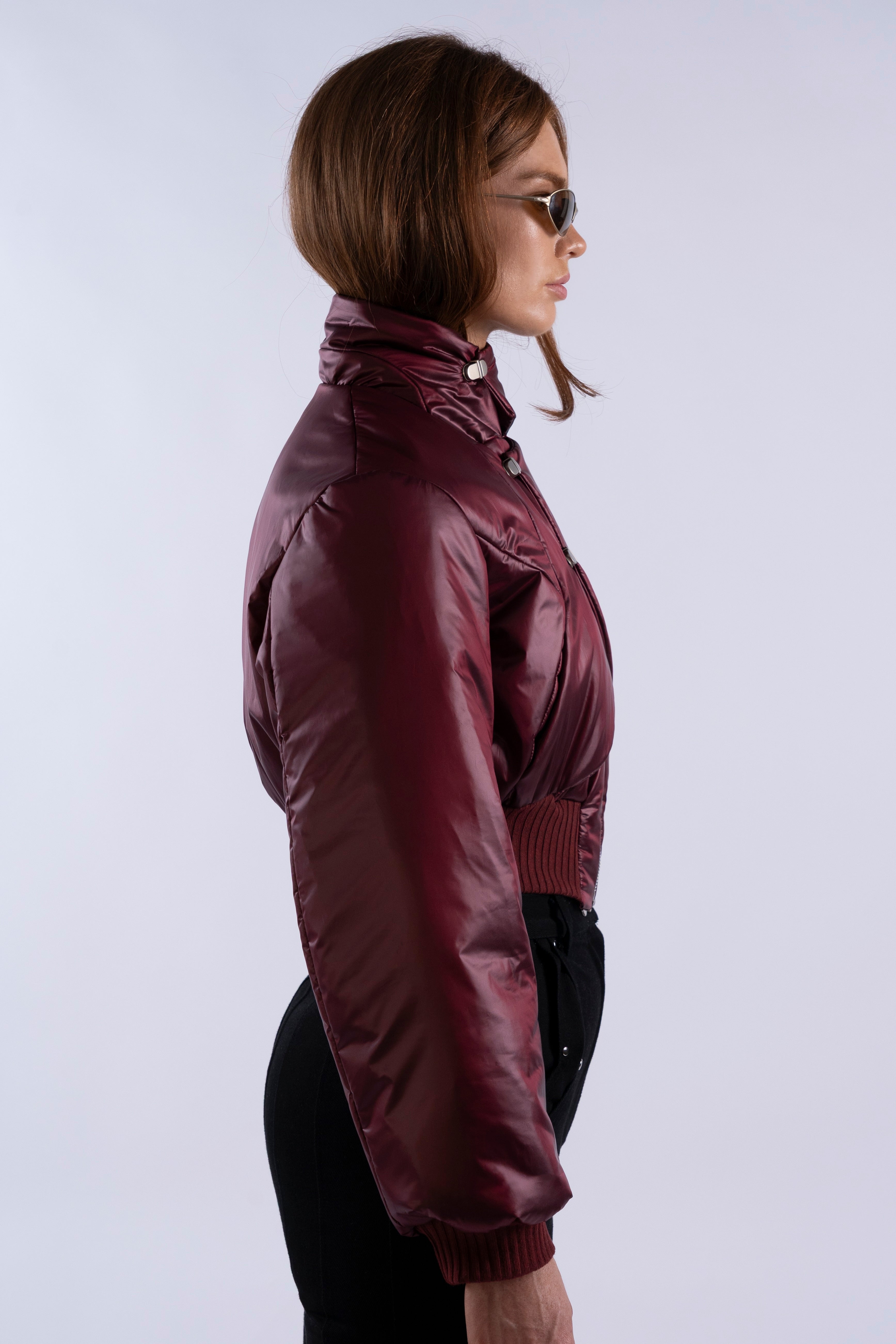 Side profile of Interface Bomber in Oxblood showing cropped cut and sleeve volume.