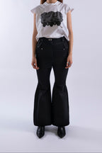 Model wearing Stadion RVT Jeans, front view showing flared silhouette and structured pockets.