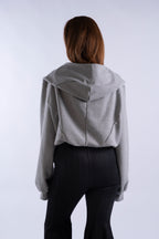 Back view of model wearing grey STN Collegiate Hoodie by Stadion, showing structured hood paneling and relaxed fit.