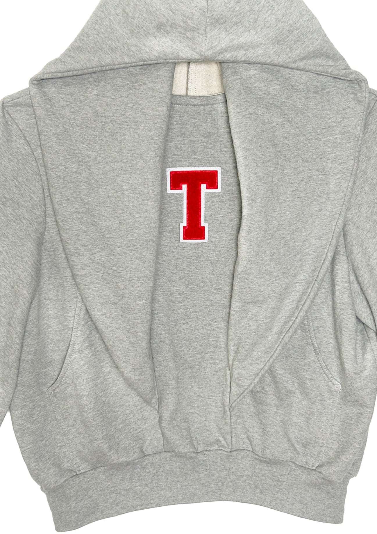Close-up of grey STN Collegiate Hoodie by Stadion showing red T chenille patch and cotton loopback texture.