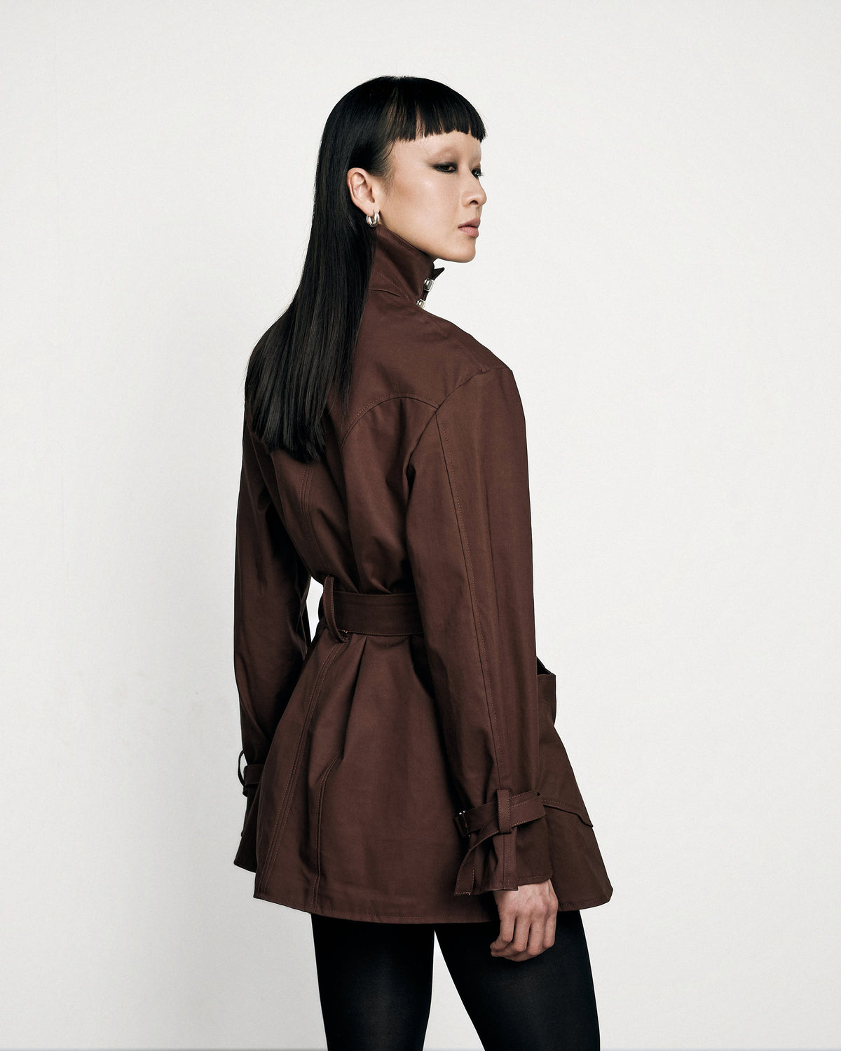 Woman wearing the Stadion Sylvia trench dress, three-quarter view from behind